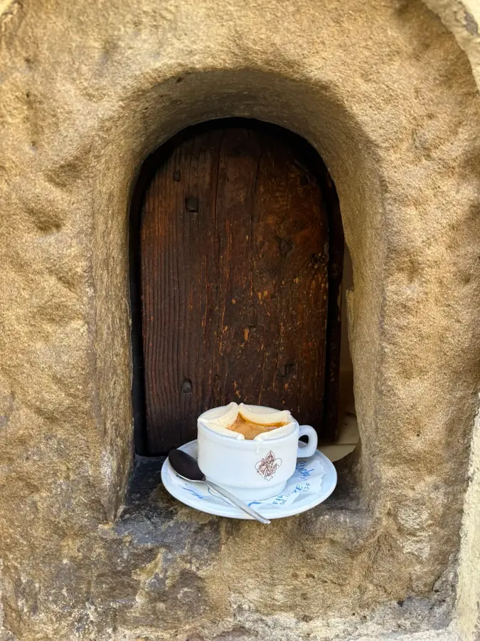 Espresso cup tucked into a stone niche in Florence