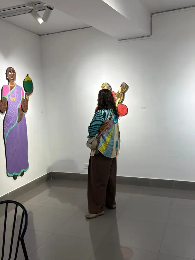 Visitor looking up at paintings in a gallery